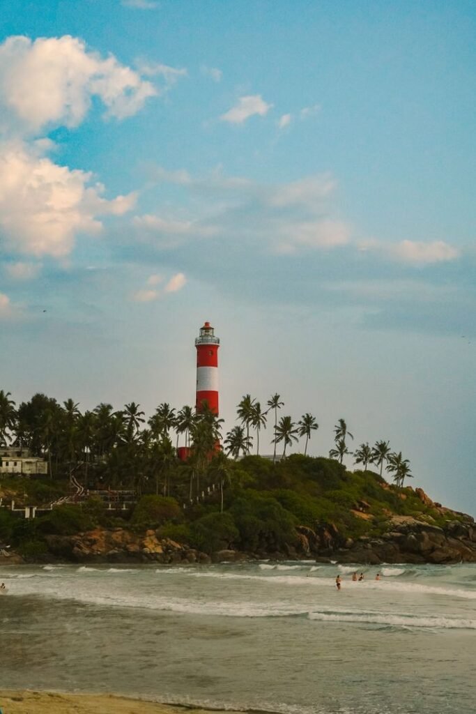 Vibrant lighthouse on lush tropical island with scenic ocean view.