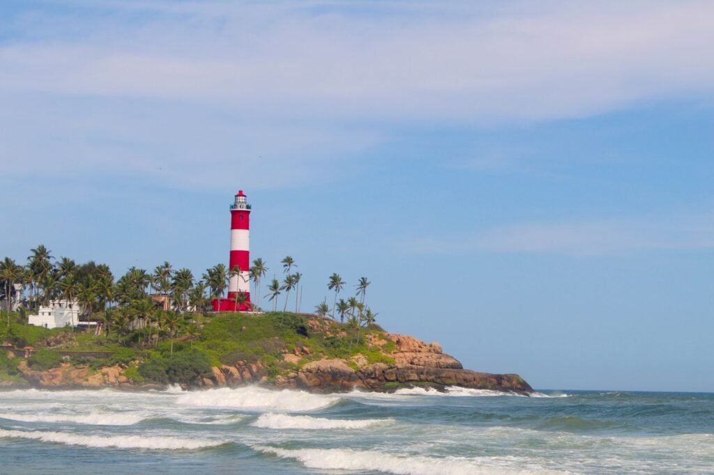 pexels photo 5192213 5192213 Captivating lighthouse on a rocky tropical coast with palm trees and a blue sky.
